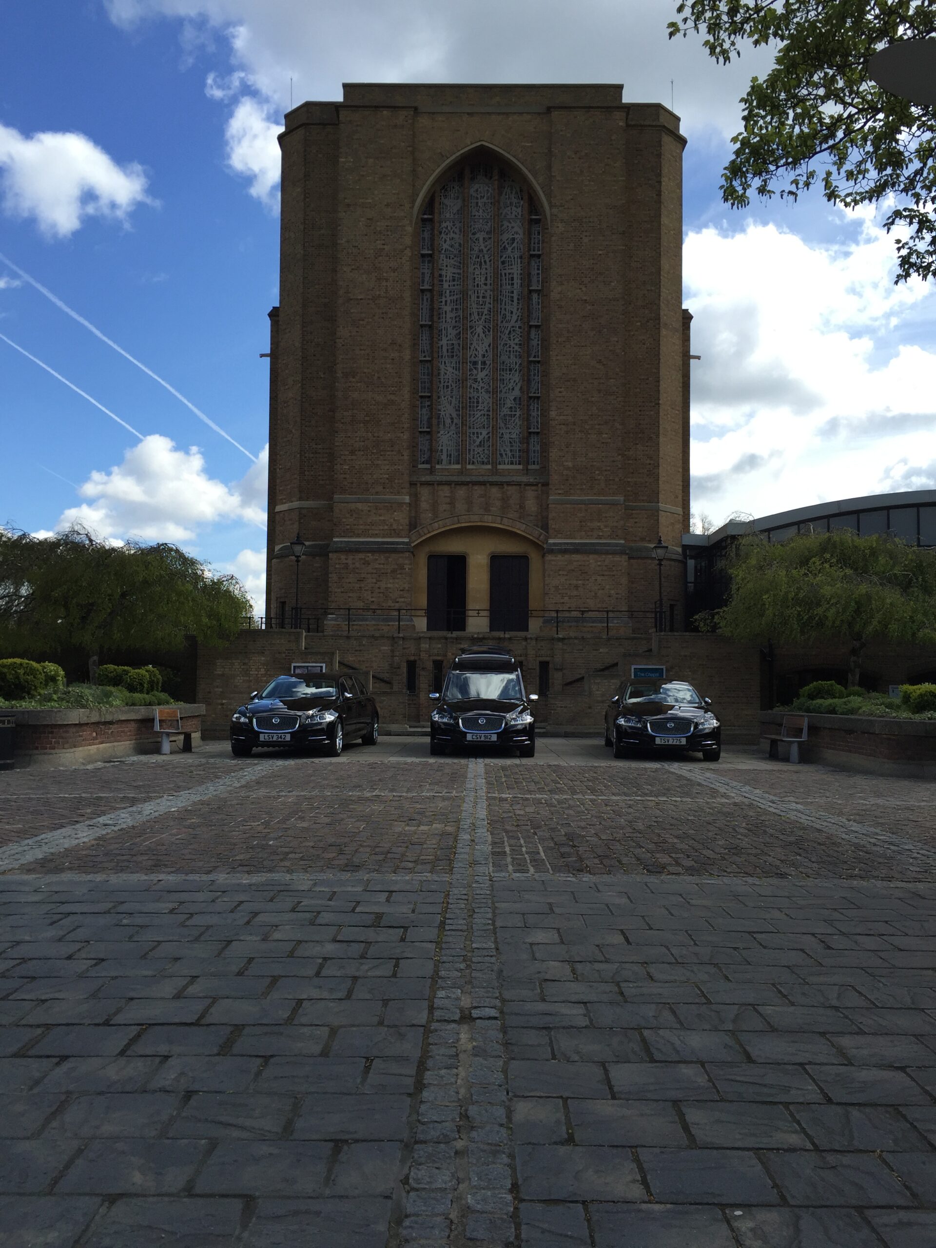 a church with hearses infront
